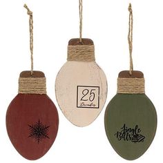 three christmas ornaments hanging from twine with price tags on each ornament for sale