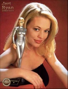 there is a woman with a silver figure on her shoulder and one arm behind her head