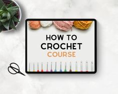 a sign that says how to crochet course on it next to yarn and scissors