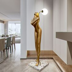 a gold statue is standing in the middle of a room