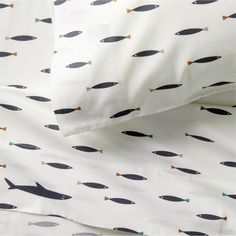 an image of a bed set with fish on it's sheets and pillow cases