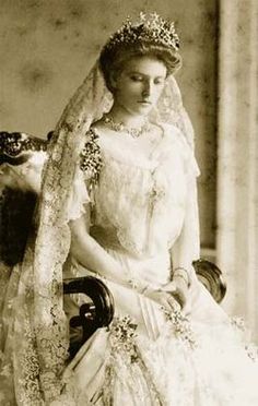 an old photo of a woman wearing a wedding dress