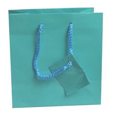 "Shipping to the Lower 48 US States only. Alaska Hawaii, PR, US Territories and APO addresses to contact us for actual shipping costs. Sold in Qty 100 Bags Gloss laminated art paper tote bag with a matching braided rope handle. This beautiful bag makes your packaging perfect when paired with tissue paper and a bow! Jewelry not included. Color: Teal Blue Size: Measures 6.5 \" x 3.5\" x 6.5\" tall. Product note: Make your packaging shine with glossy euro totes! Material: Teal paper" Blue Square Box Bag With Top Carry Handle, Blue Pouch Box Bag For Shopping, Blue Box Bag Pouch For Shopping, Blue Box Bag For Shopping, Light Blue Pouch Bag As Gift, Light Blue Pouch Bag For Gift, Blue Pouch Box Bag As Gift, Light Blue Rectangular Shoulder Bag For Gift, Light Blue Rectangular Shoulder Bag As Gift