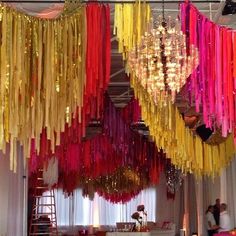 colorful streamers hanging from the ceiling in a room