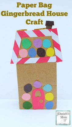 a paper bag with a house made out of circles and dots on the outside, sitting in front of a white background