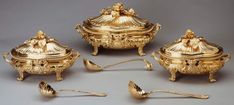 four pieces of gold in the shape of urns and spoons