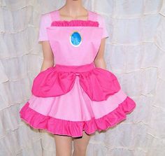 a mannequin wearing a pink dress with a blue circle on the chest and bottom