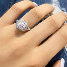 a woman's hand with a diamond ring on it