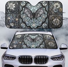 the front and rear view of a white car with an intricate design on it's windshield