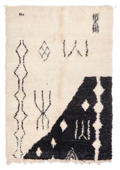 an area rug with black and white designs on it