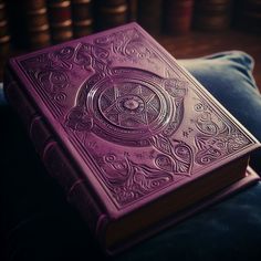 a purple book sitting on top of a blue pillow