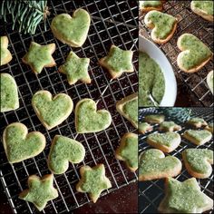 some cookies that have been shaped into hearts and are on a cooling rack with green icing