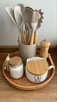 kitchen utensils are arranged in a basket on a table