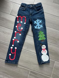 Ho Ho Ho!! Christmas season will soon be upon us, pick up these cute painted jeans for your little one! Size 5 up-cycled painted denim (Jumping Beans). Please reach out for custom painted denim and additional sizing. Cleaning instructions: spot clean, do not submerged in water Painting On Denim Jeans, Cute Painted Jeans, Christmas Jeans, Painted Denim Jeans, Denim Painting, School Spirit Week, Xmas Sweaters, School Spirit Wear, Christmas Fits