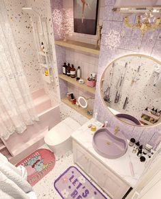 the bathroom is decorated in pastel colors and has a pink rug on the floor