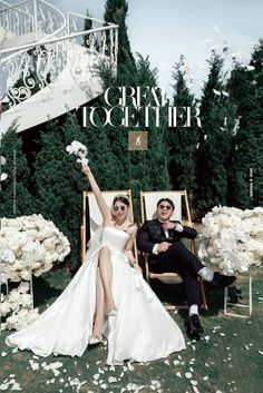 a man and woman sitting on lawn chairs in front of a staircase with white flowers