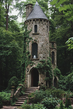 an old stone tower with ivy growing on it's sides and steps leading up to the entrance