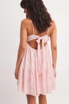 Jacquard Tie Back Detail Mini Dress Pink | NA-KD Feminine Mini Dress With Spaghetti Straps And Tie Back, Pink Floral Print Backless Sundress, Feminine Strapped Dresses For Vacation, Pink Strappy Dress For Vacation, Chic Pink Dress With Strappy Back, Pink Vacation Dress With Straps, Feminine Spaghetti Strap Dress With Tie Back, Pink Summer Suspender Dress With Spaghetti Straps, Summer Slip Dress With Tie Straps And Strappy Back