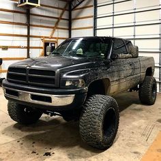 a large black truck parked in a garage