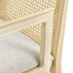 a close up view of the back of a chair with grey fabric and wood frame