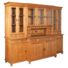 a wooden cabinet with glass doors and drawers