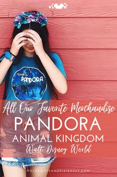 a girl standing in front of a red wall with her hands on her face and the words, all our favorite mechandos are pandara animal kingdom walt disney world