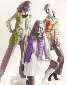 three women in dresses and sweaters posing for a photo