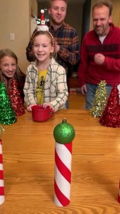 a group of people sitting around a table with candy canes