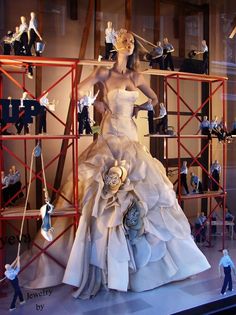 a mannequin dressed in a wedding dress on display