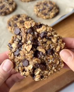 a person holding a cookie in their hand