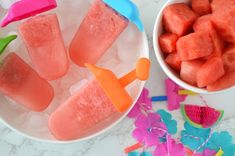 watermelon pops are in small bowls and on the table next to other decorations