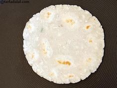 an uncooked tortilla sitting on top of a frying pan