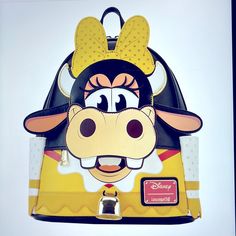 Le Clarabelle Cow Cosplay Mini Backpack And Clarabelle Cow Cosplay Bifold Wallet Simply “Moo-Arvelous!” Our Exclusive Loungefly Disney Clarabelle Cow Cosplay Mini Backpack Is The Perfect Way To Step Out In Style. Clarabelle Cow, A Fan-Favorite, Takes Shape On This Backpack In A Fun And Unique Way. Her Applique Yellow Bow Rises Up Over The Top Of The Backpack, And Her Adorable Face Appears Over The Front Zipped Pocket. Details From Her Outfit, Such As Wavy Die-Cut Edges, Continue Around The Side Cow Cosplay, Lion King Pride Rock, Clarabelle Cow, Disney Purse, Disney Pixar Up, Yellow Bow, Loungefly Bag, Disney Handbags, Disney Bag