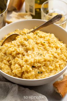 a bowl of macaroni and cheese with a spoon in it on a table