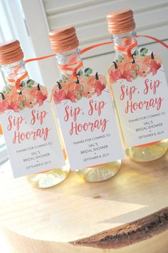 three bottles of sip - sip hooray sitting on top of a wooden table