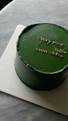 a green cake sitting on top of a white plate