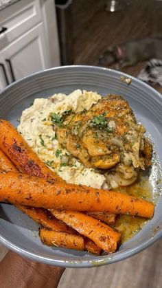 a plate with carrots, mashed potatoes and chicken