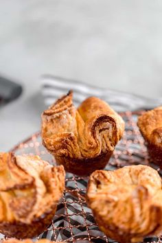 several pastries are sitting on a cooling rack