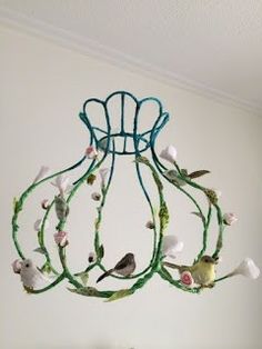 a chandelier hanging from the ceiling with birds on it