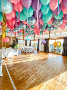 a large room with balloons and tables in it