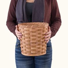 a woman holding a woven basket in her hands