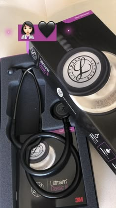 a stethoscope sitting on top of a black box next to a cd