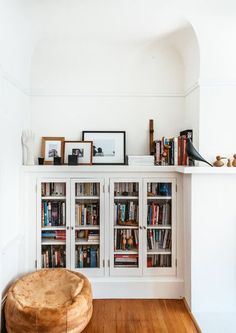 a white bookcase filled with lots of books