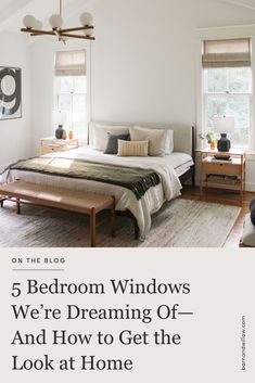 a bed room with a neatly made bed and windows