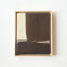 a brown and white painting in a wooden frame