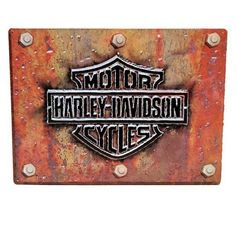 the harley davidson logo is on an old rusted metal sign that reads, motor harley davidson cycles