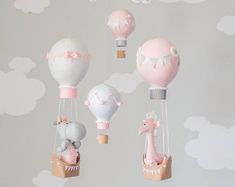 a baby crib with several hot air balloons in the sky