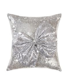 a silver sequin pillow with a large bow on the front and back of it