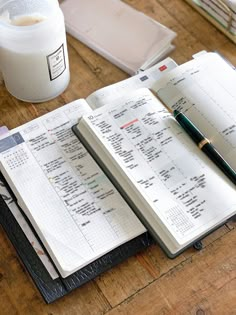 an open notebook sitting on top of a wooden table