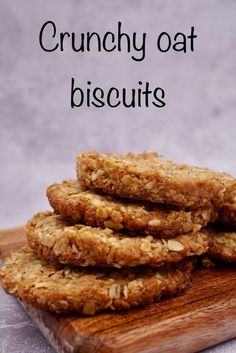 some oatmeal cookies are stacked on top of each other with the words crunchy oat biscuits above them